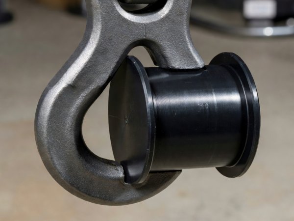 Close-up of a heavy-duty steel Y-hook cradle engaging a machined black Delrin swingarm spool
